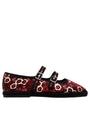 Red floral-patterned shoe with black detailing and buckles on a white background