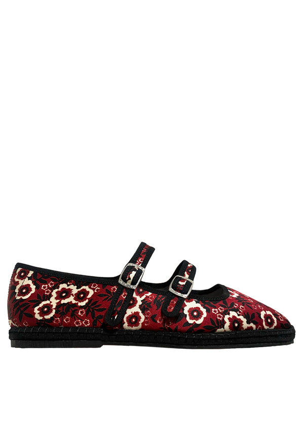 Red floral-patterned shoe with black detailing and buckles on a white background