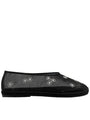 Black sheer slip-on shoe with mini white floral embroidery detail  patterns on a white background