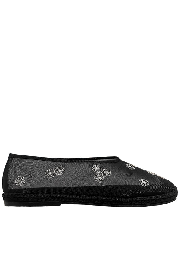 Black sheer slip-on shoe with mini white floral embroidery detail  patterns on a white background