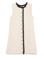 Ivory button down sleeveless dress with a round neckline and black trim details on a white background