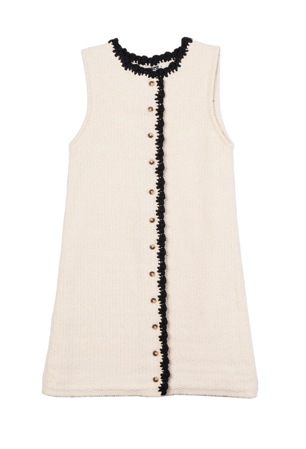 Ivory button down sleeveless dress with a round neckline and black trim details on a white background
