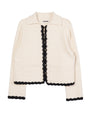 Ivory knit jacket with black trim detailing along the sleeves, hem, and center seam against a white background