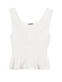 A white thick strapped tank top with a shirred scoop neckline and tiered rows of smocking around the waist against a white background. 