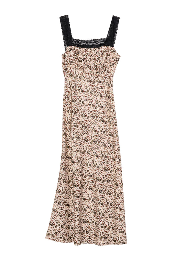 Long silky sleeveless dress with floral cherry blossoms pattern with black lace neckline and straps against a white background. 