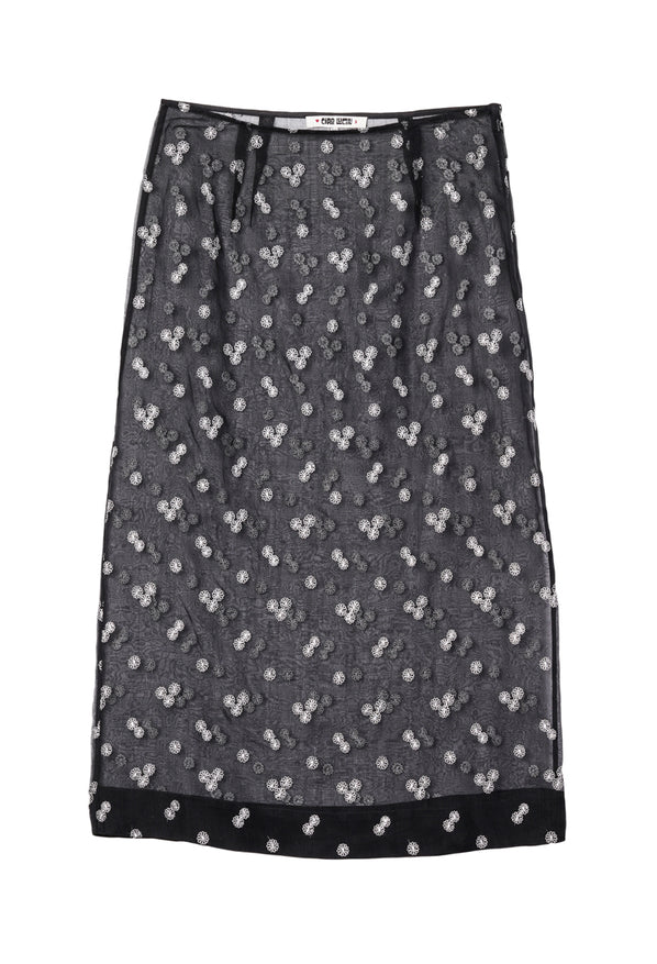Black sheer midi skirt with small embroidered flowers against a white background. 